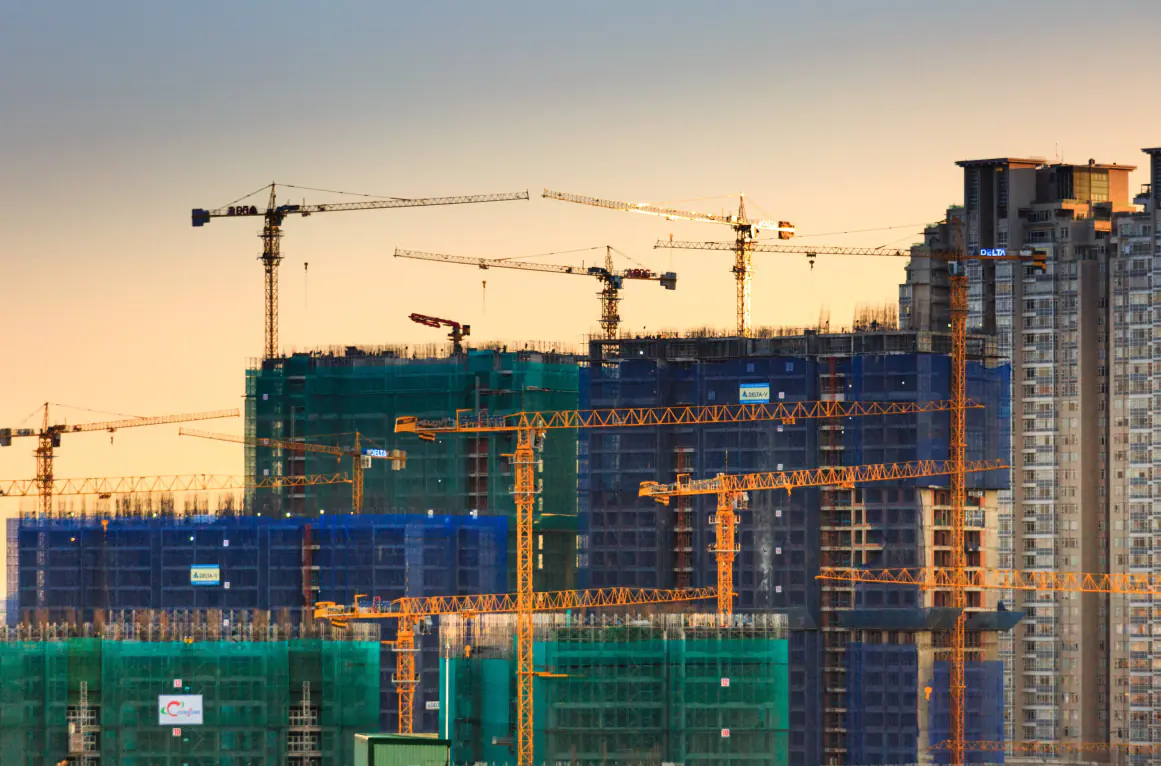 Construction — tower cranes at dusk